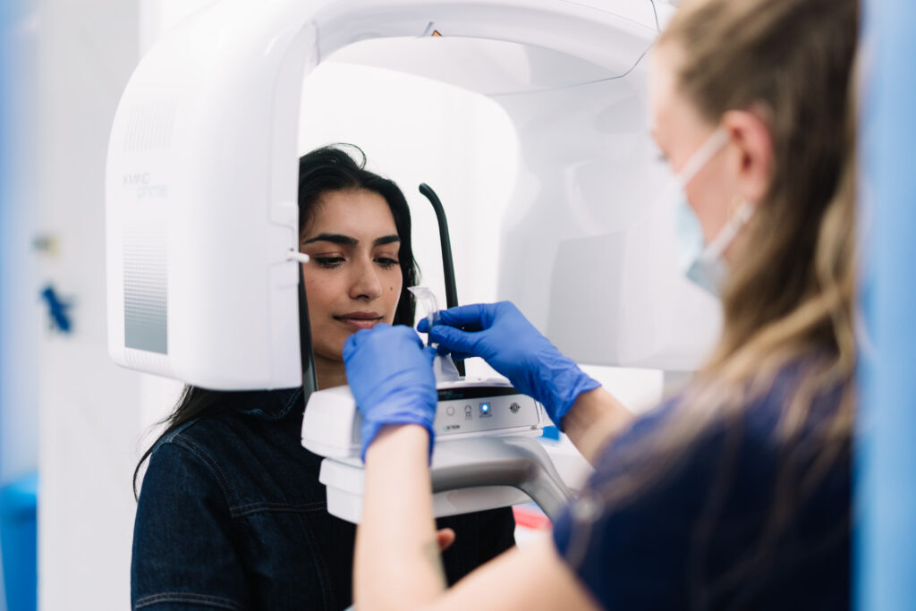 Patient having cone beam CT (CBCT) scan at London oral surgery clinic.