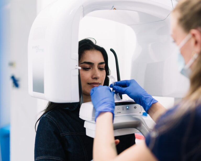 Patient having cone beam CT (CBCT) scan at London oral surgery clinic.