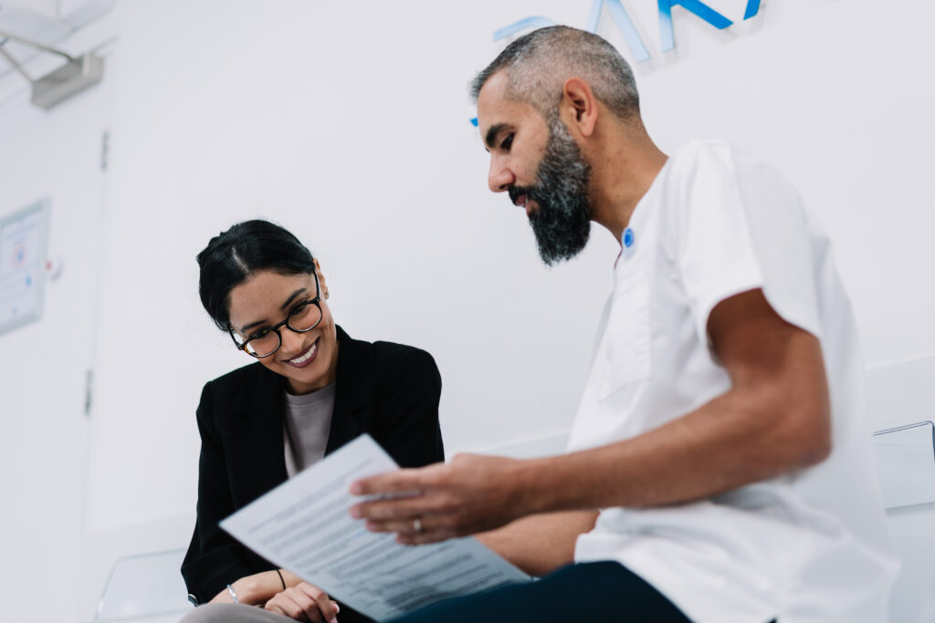 Dental Surgeon Consulting Patient