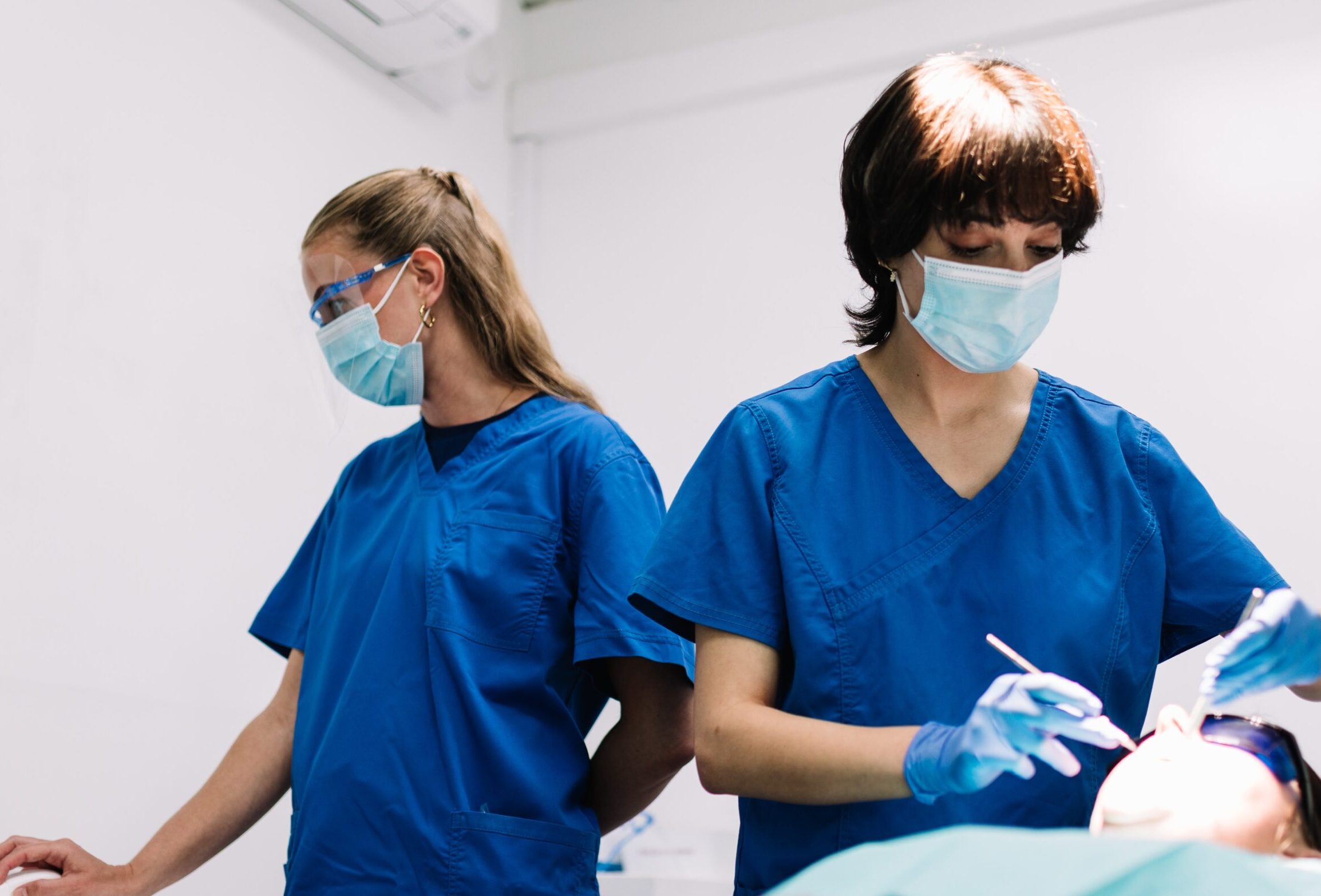 Dental hygienist performing deep gum cleaning for periodontal disease
